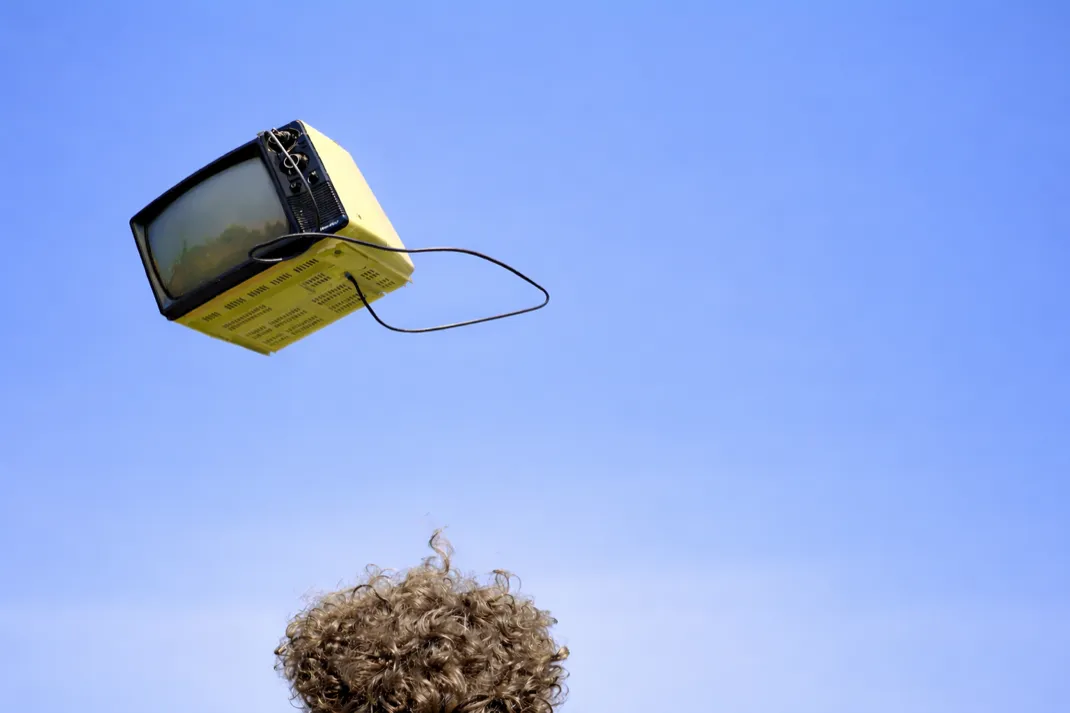 Vintage television floating against blue sky